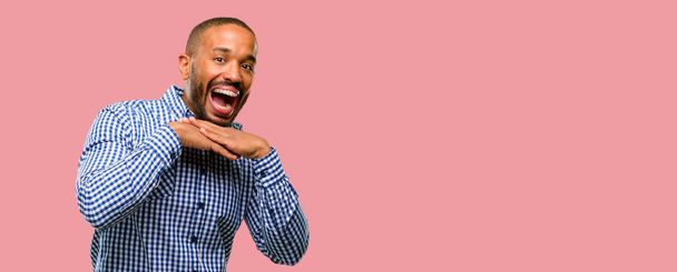 Hombre afroamericano con barba feliz y sorprendido vitoreando expresando un gesto de sorpresa
 - Foto, Imagen