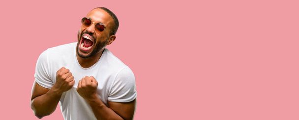 African american man with beard happy and excited celebrating victory expressing big success, power, energy and positive emotions. Celebrates new job joyful - 写真・画像