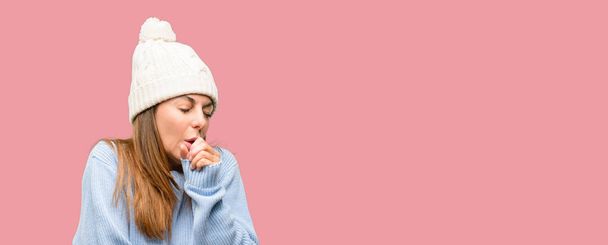 Middle age woman wearing wool winter cap sick and coughing, suffering asthma or bronchitis, medicine concept - Photo, Image