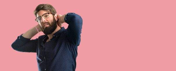 Young hipster man with big beard confident and happy with a big natural smile laughing - 写真・画像