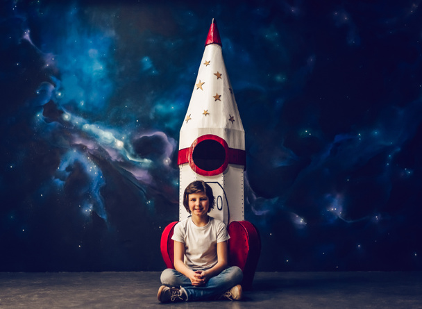 Boy with toy rocket in space - Photo, Image