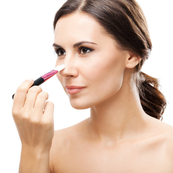Smiling woman with make up brush, isolated - Foto, Bild