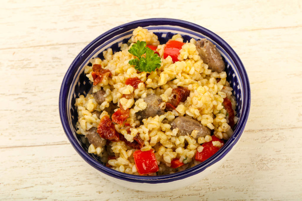 Bulgur with chicken hearts and dry tomatoes - Photo, Image