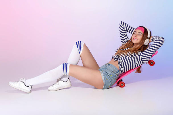 beautiful woman with skate in studio - Photo, Image