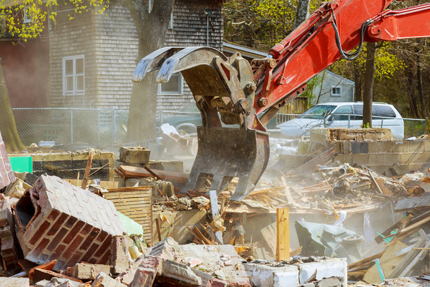 Demolition of an old house, wooden planks and rubble and the ruins of the house for new construction project. - Photo, Image