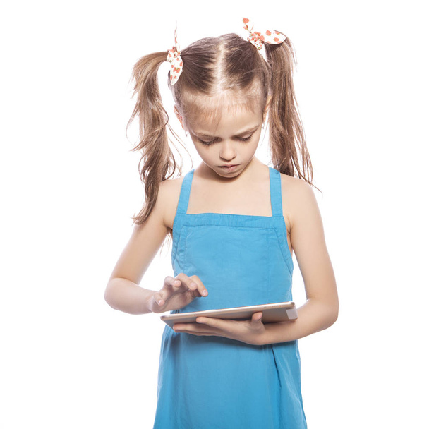 Young seven years old brunette girl in blue dress on a white iso - Photo, Image