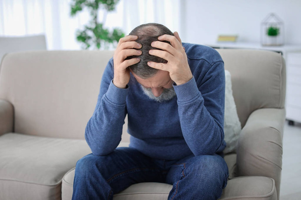 Mature man suffering from headache at home - Photo, Image