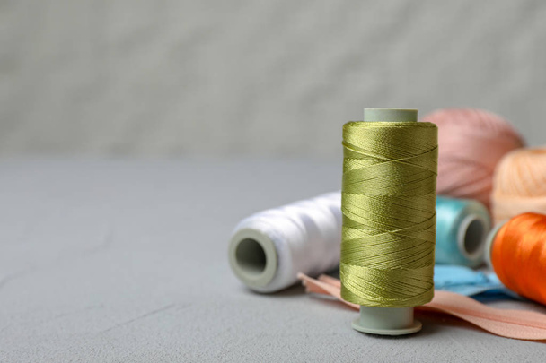 Color sewing threads on table - Фото, зображення