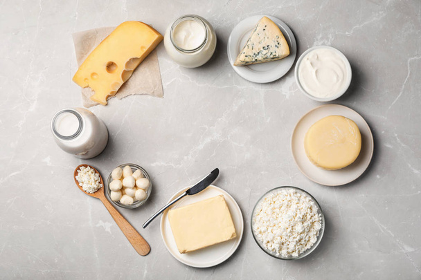 Frame of fresh dairy products on gray background, top view - Foto, imagen