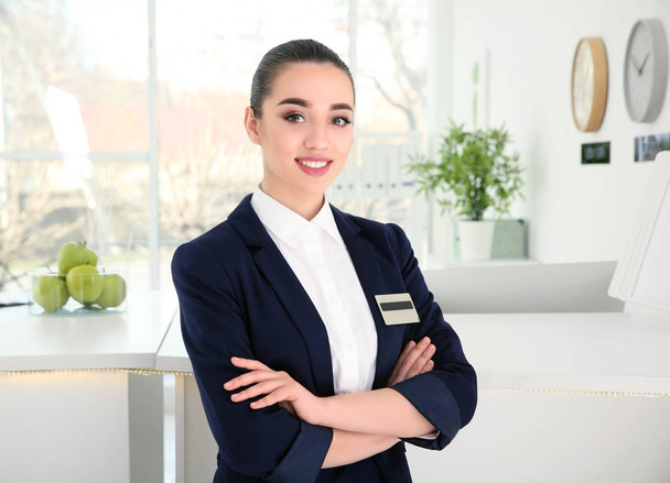 Female receptionist at workplace in hotel - Φωτογραφία, εικόνα