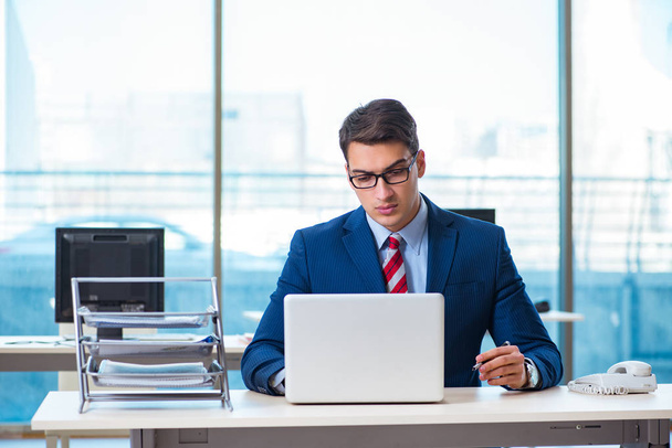 Young handsome businessman employee working in office at desk - Foto, Imagen