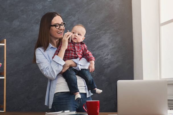 Young working mother spending time with baby - Photo, Image