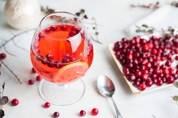 Christmas still life with cranberriy punch and blurred snow outside the window. Festive and bright - 写真・画像