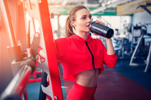 fitness girl with shaker posing in the gym - Fotoğraf, Görsel