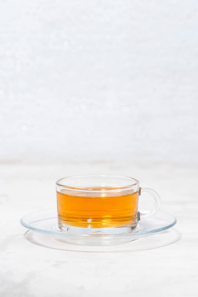 fragrant tea in a glass cup on a white background, vertical - Фото, зображення