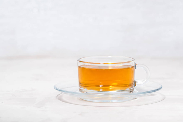 fragrant tea in a glass cup on a white background - Фото, зображення