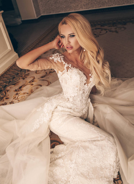 fashion interior photo of beautiful sensual woman with blond hair in luxurious wedding dress and accessories - 写真・画像