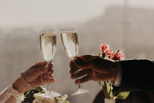 愛の若いクーペ豪華なレストランでロマンチックな日付がある、スパーク リング白ワインやシャンパンのグラスをチャリンという音、自分の婚約を祝うため - 写真・画像