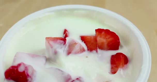 close-up of healthy strawberry and white yogurt man use the spoon for eat, concept of healthy food nutrition  - Filmagem, Vídeo