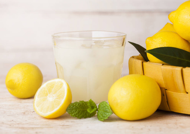 Glass of organic fresh lemon juice and fruits - Photo, Image