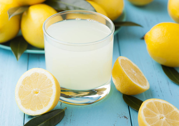 Glass of organic fresh lemon juice and fruits - 写真・画像