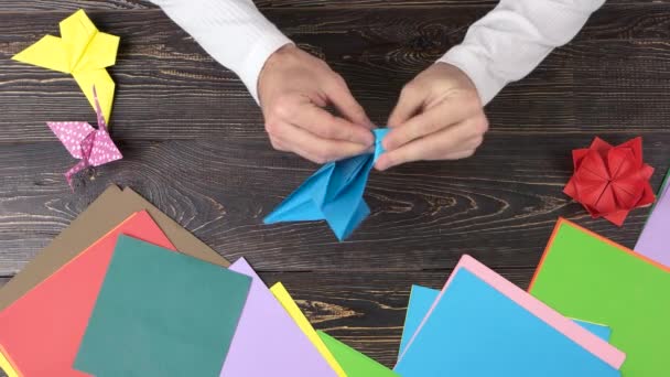 Man doing origami crane, top view. - Footage, Video