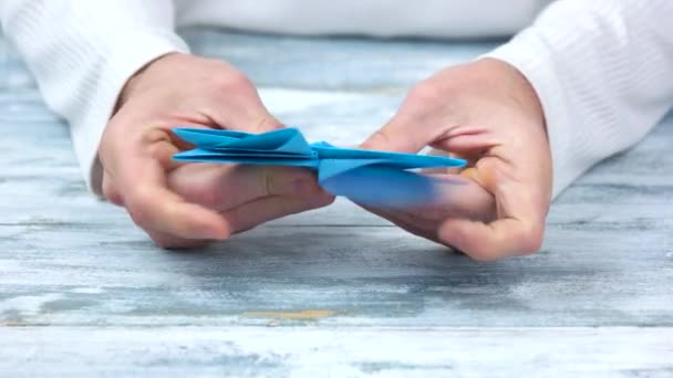 Close up male hands folding origami figure. - Footage, Video