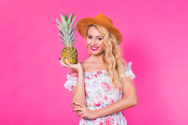 Portrait of happy woman and pineapple over pink background. Summer, diet and healthy lifestyle concept - Photo, image