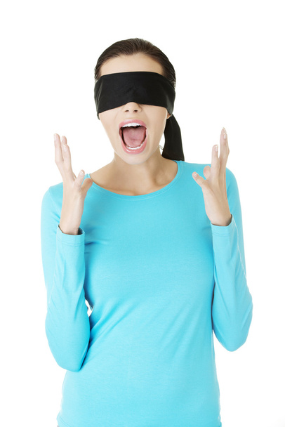 Beautiful frighten young blindfold woman screaming - Foto, imagen