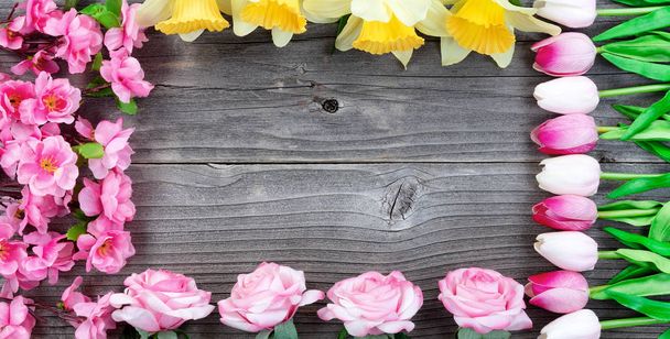 Rectangle border of seasonal flowers on vintage wood in overhead - Photo, Image