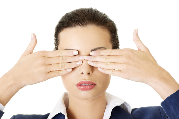 Attractive businesswoman covering her eyes - Фото, изображение