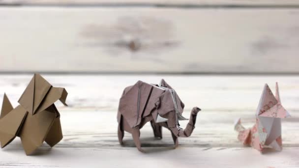 Set of origami animals on wooden background. - Footage, Video
