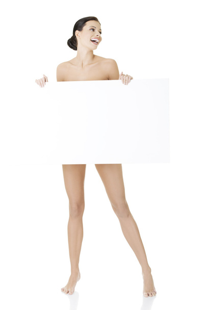 Sexy naked brunette holding empty board - Foto, afbeelding