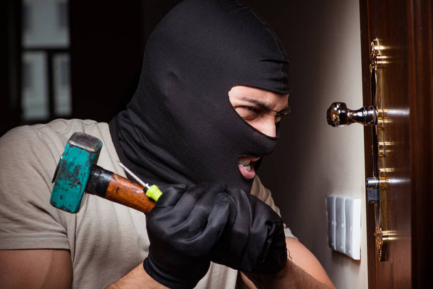 Burglar wearing balaclava mask at crime scene - Photo, Image