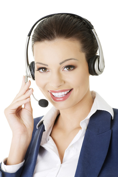 Beautiful young call-center assistant smiling - Foto, afbeelding