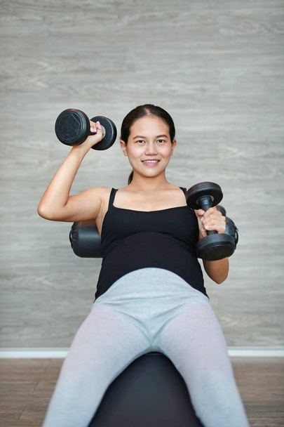Close Up Of Pregnant Woman Exercising With Weights - Photo, image
