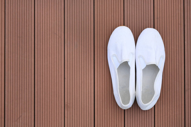 White casual shoes on wood plank background - Φωτογραφία, εικόνα