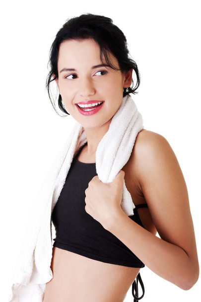 Woman in sports clothes with towel on neck - Photo, image