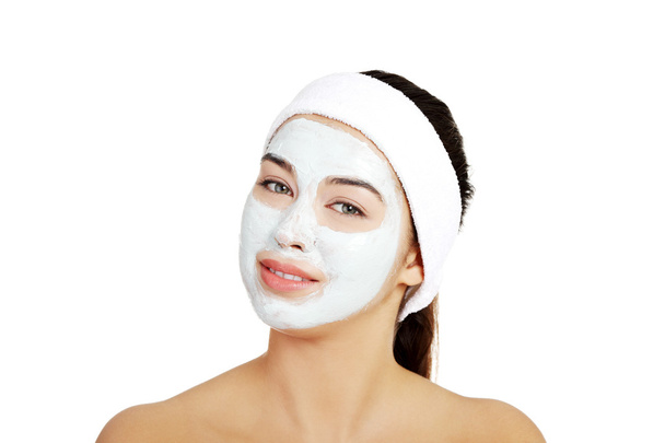 Beautiful woman with clay facial mask - Photo, Image