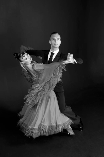 dance ballroom couple beautiful dress dance pose isolated on black background. sensual professional dancers dancing walz, tango, slowfox and quickstep. black and white - Foto, afbeelding