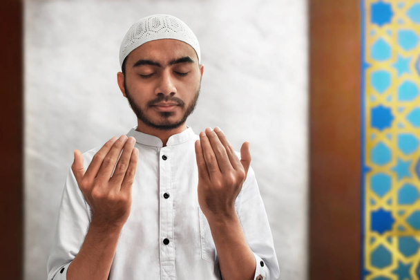 Muslim man praying in mosque - Фото, изображение