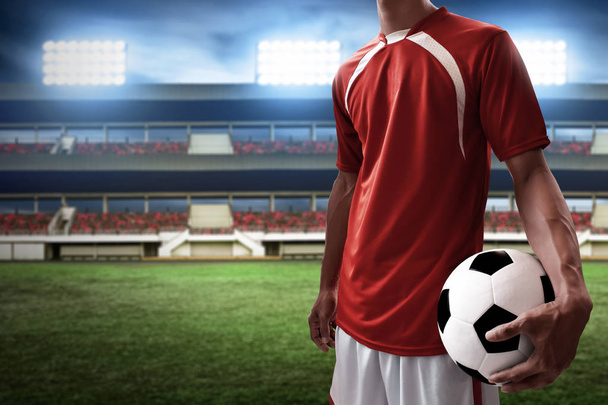 Soccer player holding soccer ball - Φωτογραφία, εικόνα