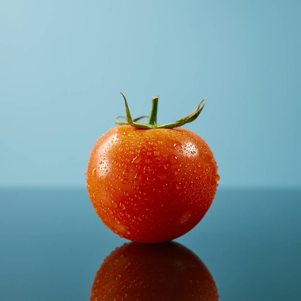 fresh ripe tomato on blue background - Fotografie, Obrázek