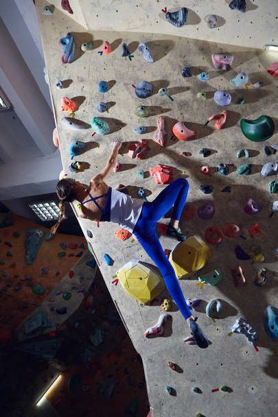 woman climber climbs indoors - 写真・画像