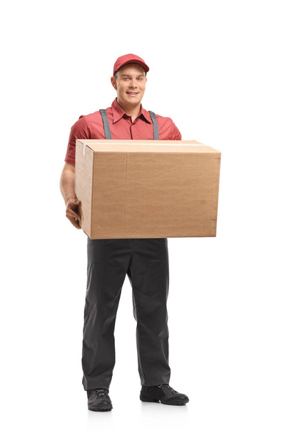 Full length portrait of a mover holding a box isolated on white background - Photo, image