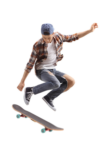 Teenage skater boy jumping isolated on white background - Foto, imagen