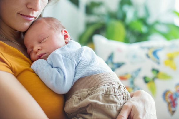 Young mother, holding tenderly her newborn baby boy - Valokuva, kuva