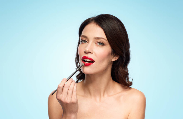 beautiful woman with make up brush for lipstick - Zdjęcie, obraz