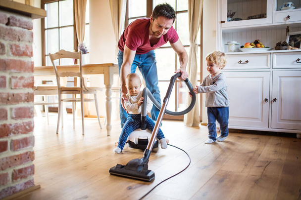 Father and two toddlers doing housework. - Foto, immagini