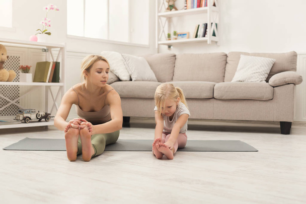 Happy mother and daughter having training at home - Photo, image